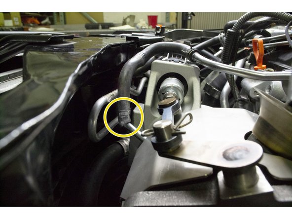 Use pliers to install the spring clamp at the end of the coolant hose around the upper coolant pipe