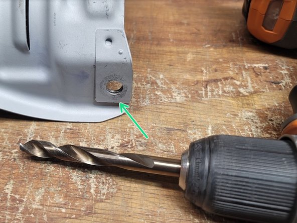 Drill out the four holes in OE heat shield using 3/8&quot; Drill Bit