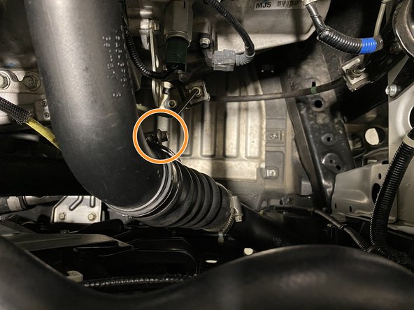 Loosen the band clamp with a flathead or 8mm socked and ratchet