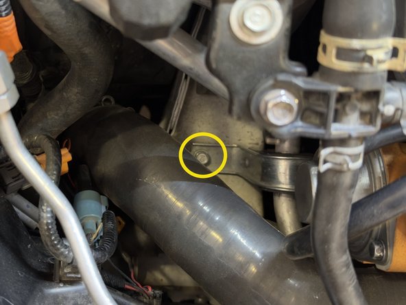 Optional: Loosen upper bracket for factory A/C line using 10mm socket and ratchet