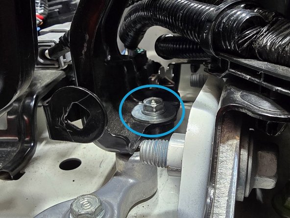 Hand thread the 40mm bolt through the ECU bracket and spacer as shown