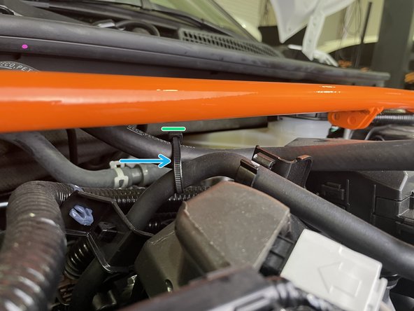 Push down on the vaccum hose and loosely zip tie  it to the adjacent hose