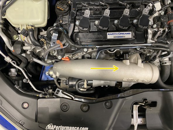 Rotate and lower the TIP into the engine bay then move it towards the driver's side of the engine bay