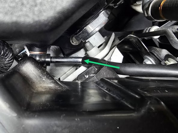 Press the coolant hose over the coolant tank barb fitting as shown