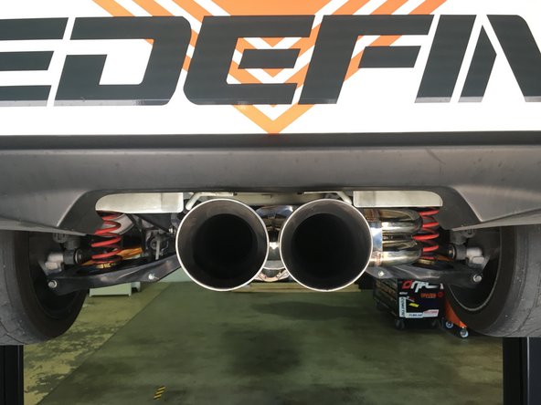 If the tips are not centered try gently shaking the exhaust to settle the rubber hangers