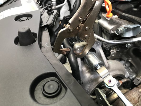 Use small vise grips/clamp to pinch the upper coolant hose on the turbo in the area indicated by the red arrows