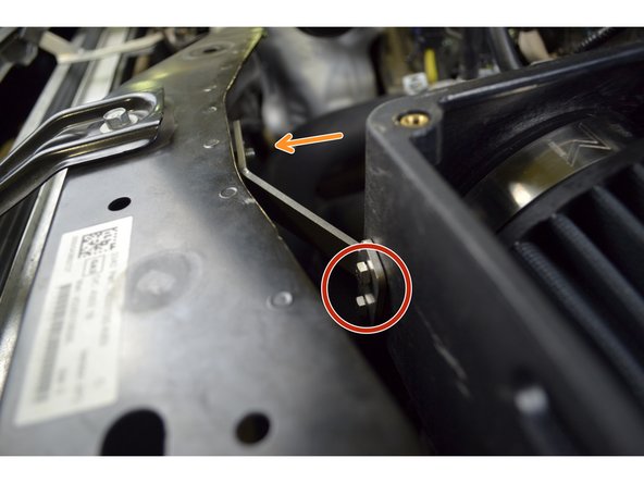 Aline the slotted end of the short bracket onto the rubber isolator