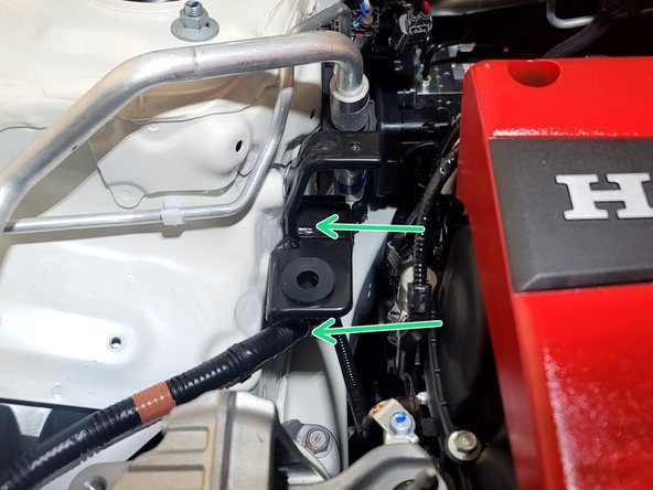 Use a 3/8" ratchet and 10mm socket to remove (2) 10mm bolts securing the lower chassis tank bracket