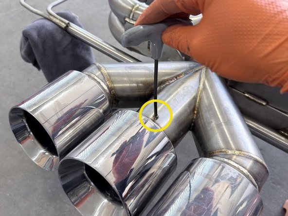 Insert first Allen head bolt into newly created top hole and into the silencer