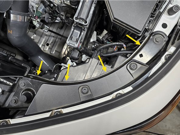 Tuck the wire under the headlight mounting plate as shown