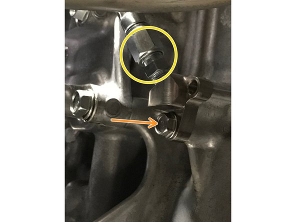Insert the fitting block onto the protrusion (red circle to red circle) and then align the hole on the block fitting with the hole in the engine (orange circle to orange circle), then install the OE 10mm bolt.  Torque to 9-11 ft-lbs