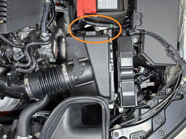 The battery cables will need to be reconnected to the airbox in the location shown