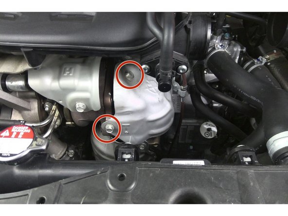 Reinstall the OEM upper heat shield using only two (2) of the three OEM bolts Torque to 18 ft-lbs.