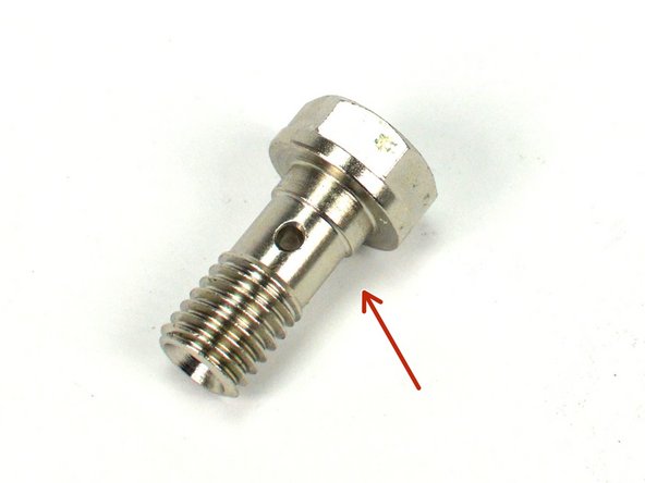 Locate the provided oil feed banjo bolt and two (2) M10 copper crush washers