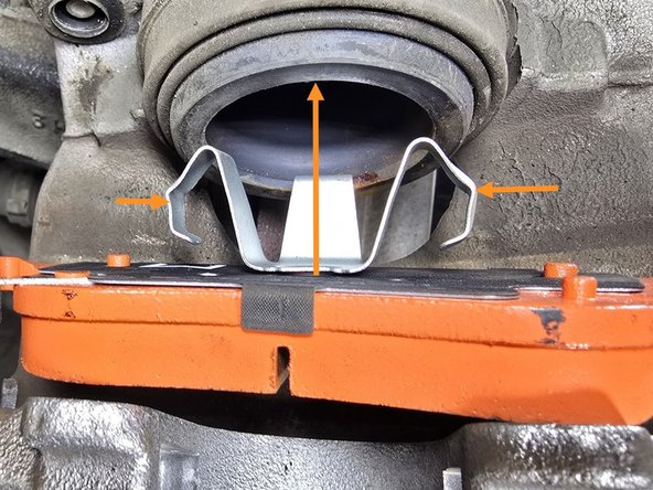 Install the inner brake pad into the caliper cylinder by compressing the outer retaining clips and pressing the pad into the caliper as shown