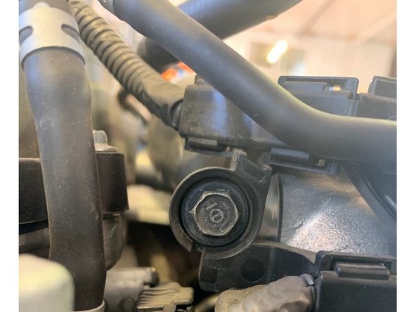 Using  the OE 10mm bolt reinstall the upper part of the wire loom as shown