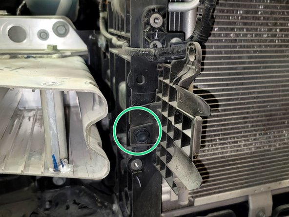 Remove both shrouds by pulling push clip as shown