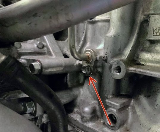 Reconnect the bottom side of the oil feed line using the OE 10mm bolt. Torque to 9 ft-lb 