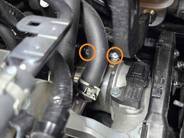 Use a 10mm socket, a 6" extension, and a 3/8" drive ratchet loosen the two hose clamps securing the OEM silicone