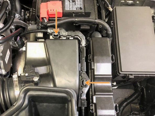 Unclip the MAF sensor wiring from the OEM airbox by sqeezing the two tabs shown by orange arrows then pull up