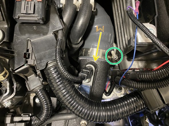 Place the T-Bolt clamp as shown and tighten with a 10mm socket and ratchet until the silicone bulges slightly