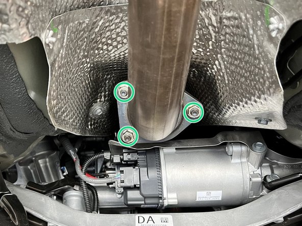 Using a 14mm socket, remove the (3) bolts shown to unbolt the front pipe (not shown) from back part of exhaust (shown)