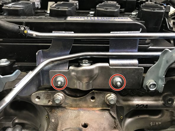 Use a flat head screwdriver to open the plastic clip holding the rearward coolant hose, as shown in the third image