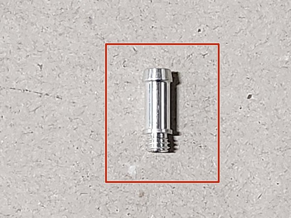 Locate the small silver vacuum barb in your hardware packet