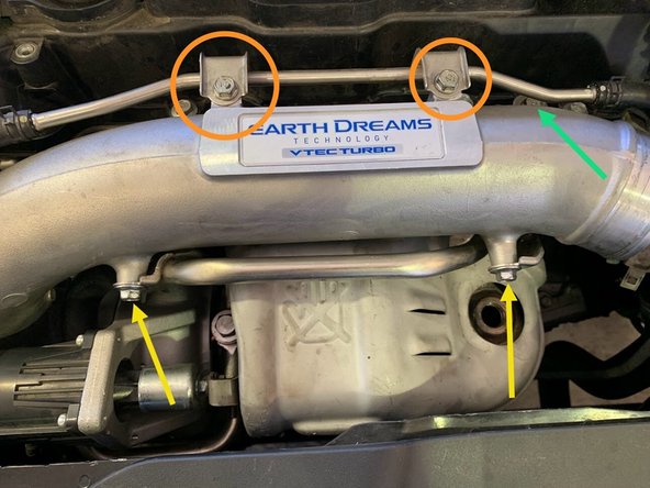 Reinstall the (2) OE 10mm bolts to mount the top hard line to the intake pipe