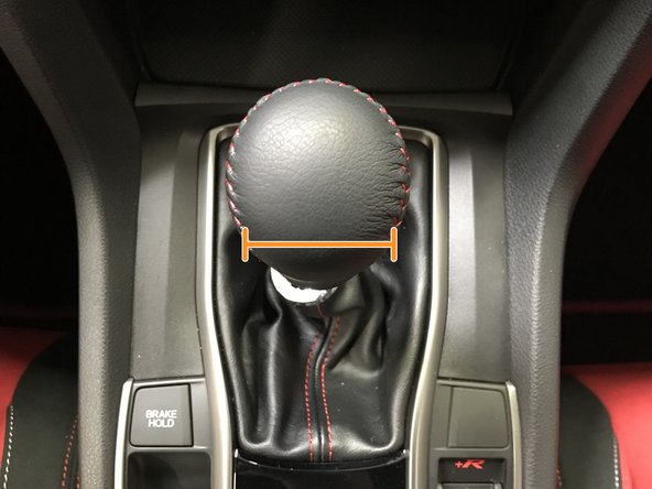 Unthread the shift knob until the desired orientation is achieved as shown