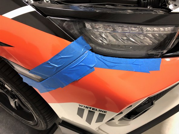 Apply masking or painters tape around the seams where the bumper meets the body of the car