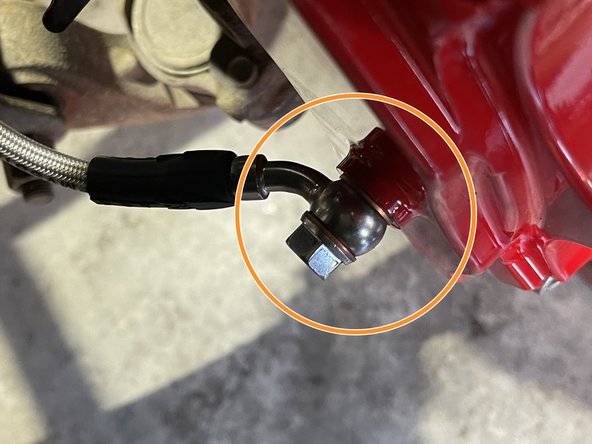 Install the front brake line into the front caliper using the supplied banjo bolt and (2) crush washers