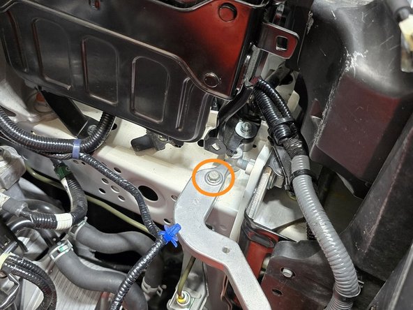 Using a 10mm socket, a long extension, and a 3/8&quot; drive ratchet remove the 10mm bolt shown