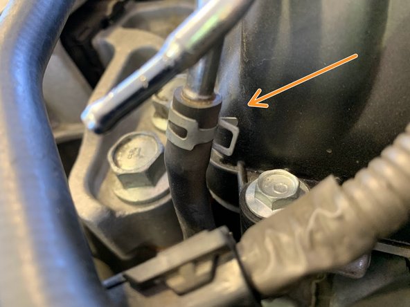 Using Needle nose pliers, undo the clamp on the silicone section sitting just above the oil control solenoid electrical pigtail from the previous step.  Free the hose from the hard line