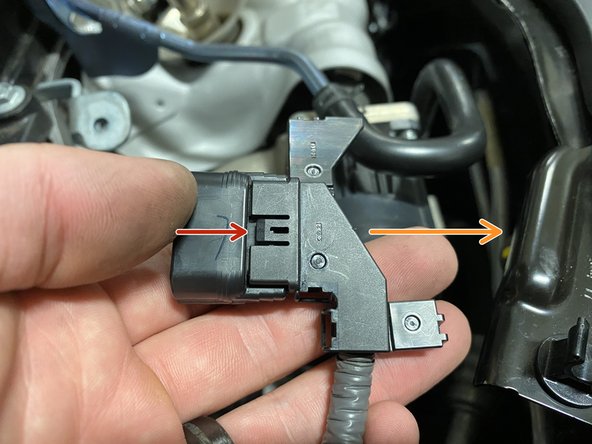 Using a small flat head screwdriver, pry the &quot;loop&quot; tab up