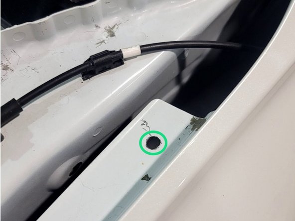 Use a punch, marker, or even a screw driver and mallet to mark a spot on the fender to add a hole