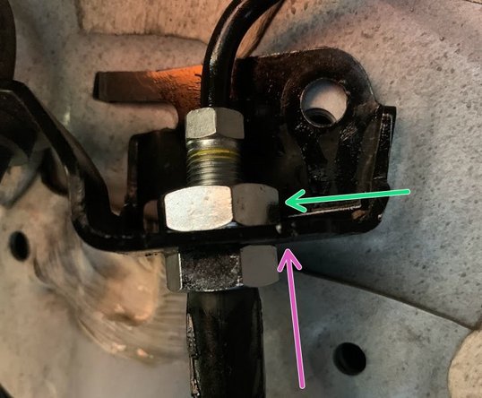 Route the brake line through the chassis mounting bracket in the direction indicated by yellow arrow