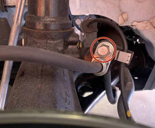 Use a 12mm socket and ratchet to remove the bolt shown with red circle
