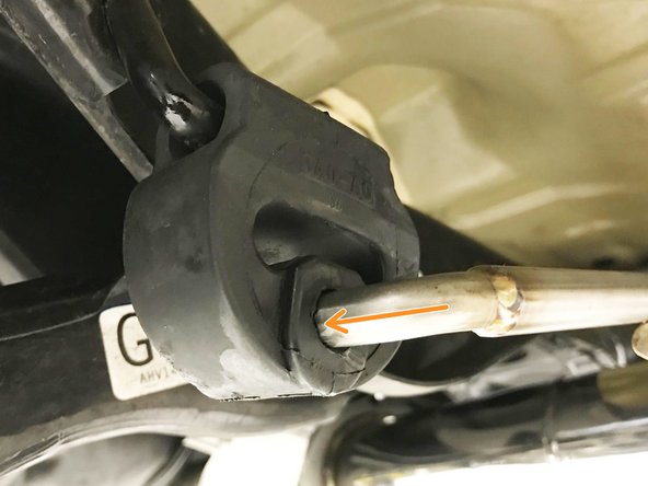 While supporting the rear of the muffler section, insert both forward hangers as shown