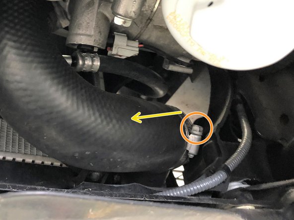 Loosen the clamp that attaches the OEM hot side boost tube to the intercooler using a 10mm socket and ratchet