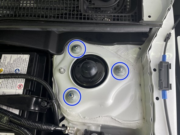 Remove three (3) flange nuts with a 14mm deep socket and ratchet wrench from the passenger side