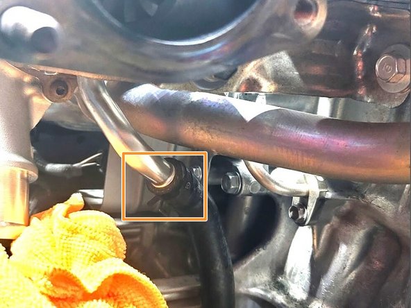 Use pliers to slide clamp down rubber oil return hose