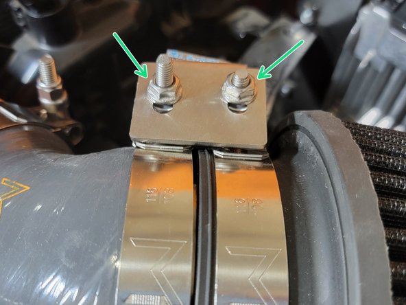 Set bracket over clamp nuts and finger tighten the same two M6 nuts back in place