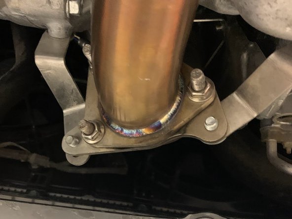 Align the studs through the flange then hand tighten the  nuts