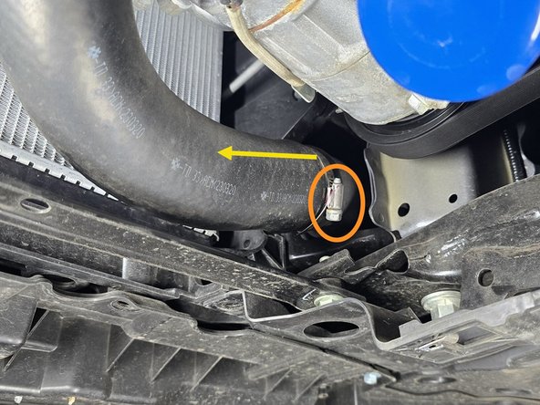 Loosen the clamp that attaches the OEM hot side boost tube to the intercooler using a 10mm socket and ratchet