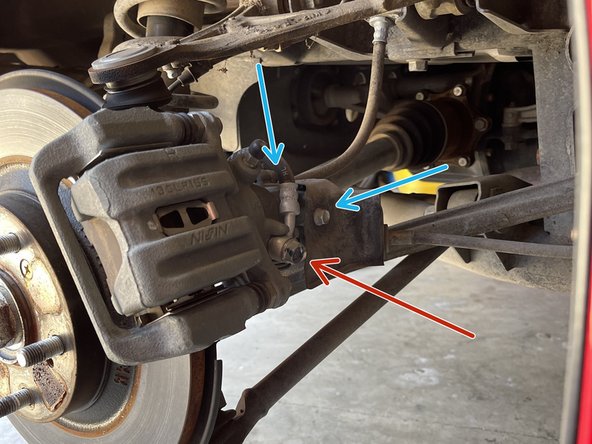 Place a drain pan under the caliper to catch brake fluid from brake hose