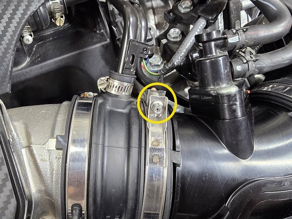 Use a 5.5mm socket and 3/8&quot; ratchet or a small Phillips screwdriver to loosen the one EVAP elbow clamp circled in yellow