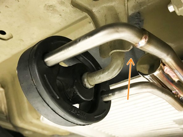 Verify that the hanger bar is not contacting the chassis.  Move the muffler section rearward if the hanger bar is very close or touching the chassis