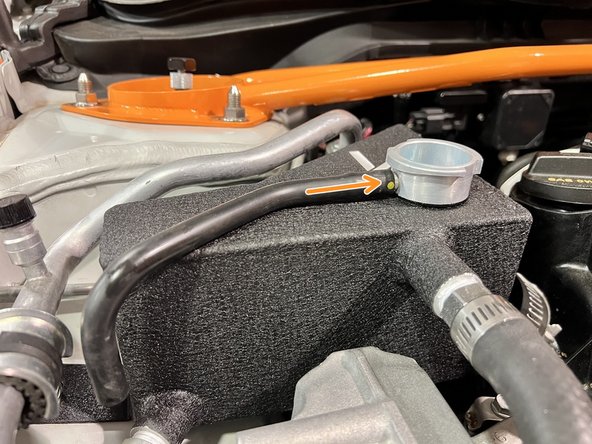 Install OEM overflow hose onto 27WON tank by pushing it on barb as shown