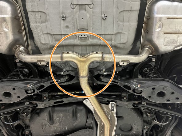 Using a transmission jack, floor jack, or a friend support the OE exhaust in the marked area